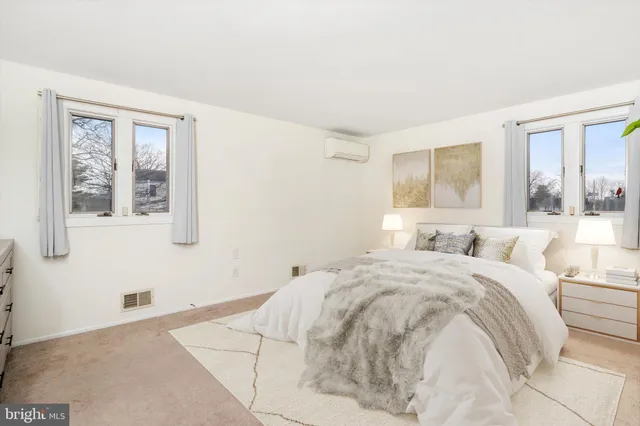 a spacious bedroom with a bed and a window