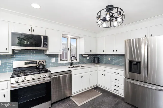 a kitchen with a sink stove and microwave