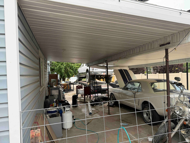 1225 South Main Street Mapleton, UT 84664 - Photo 8 of 9 Covered carport featuring a concrete floor, light blue vinyl siding, and a white fence perimeter