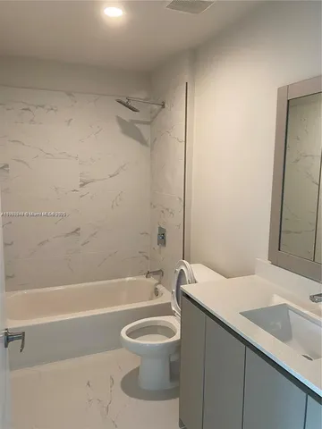 a bathroom with a toilet a sink and bathtub