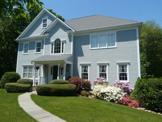 a front view of a house with a garden