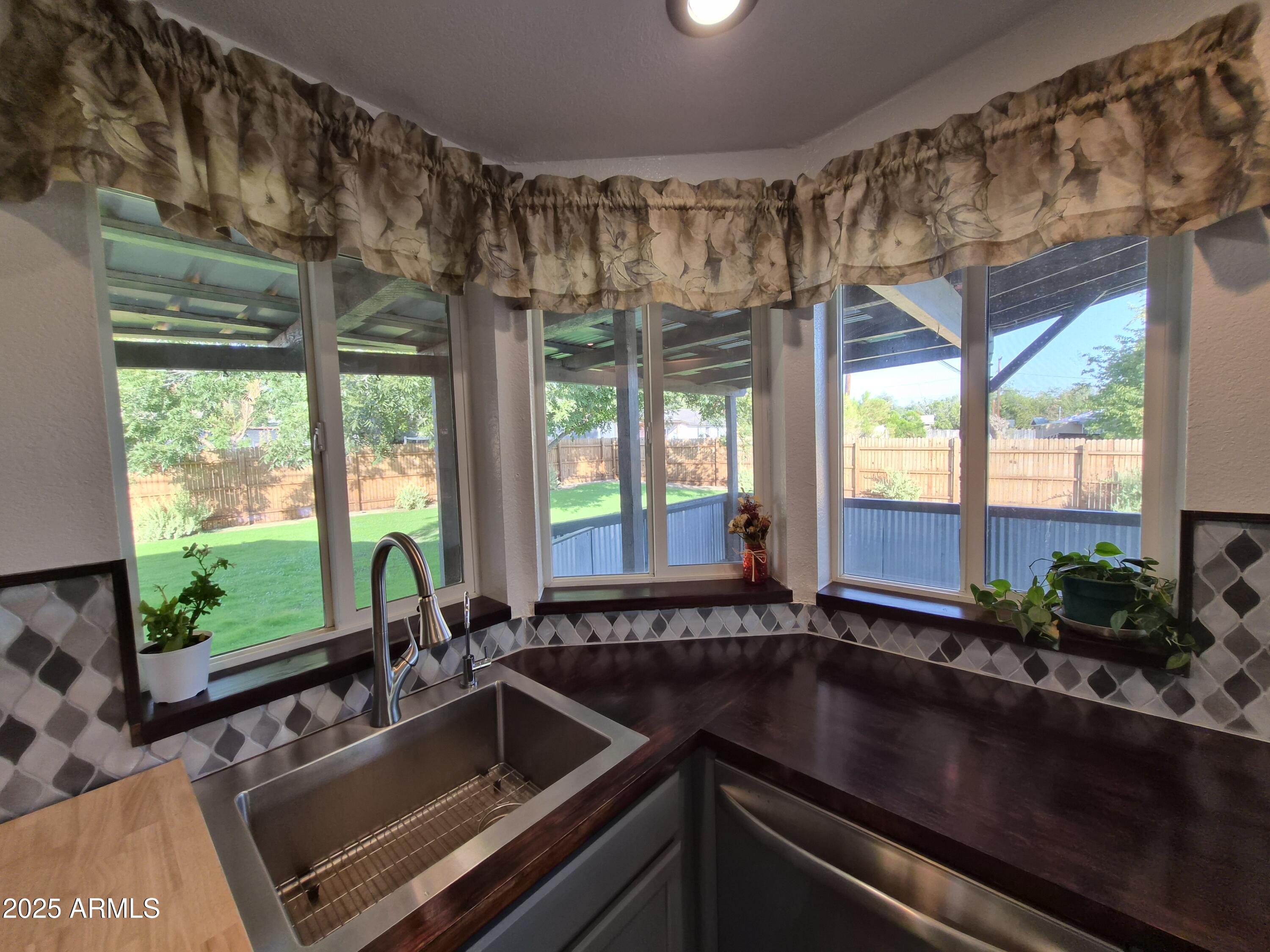 51033 North Mockingbird Road Wickenburg, AZ 85390 - Photo 12 of 51 a kitchen with a sink and large window