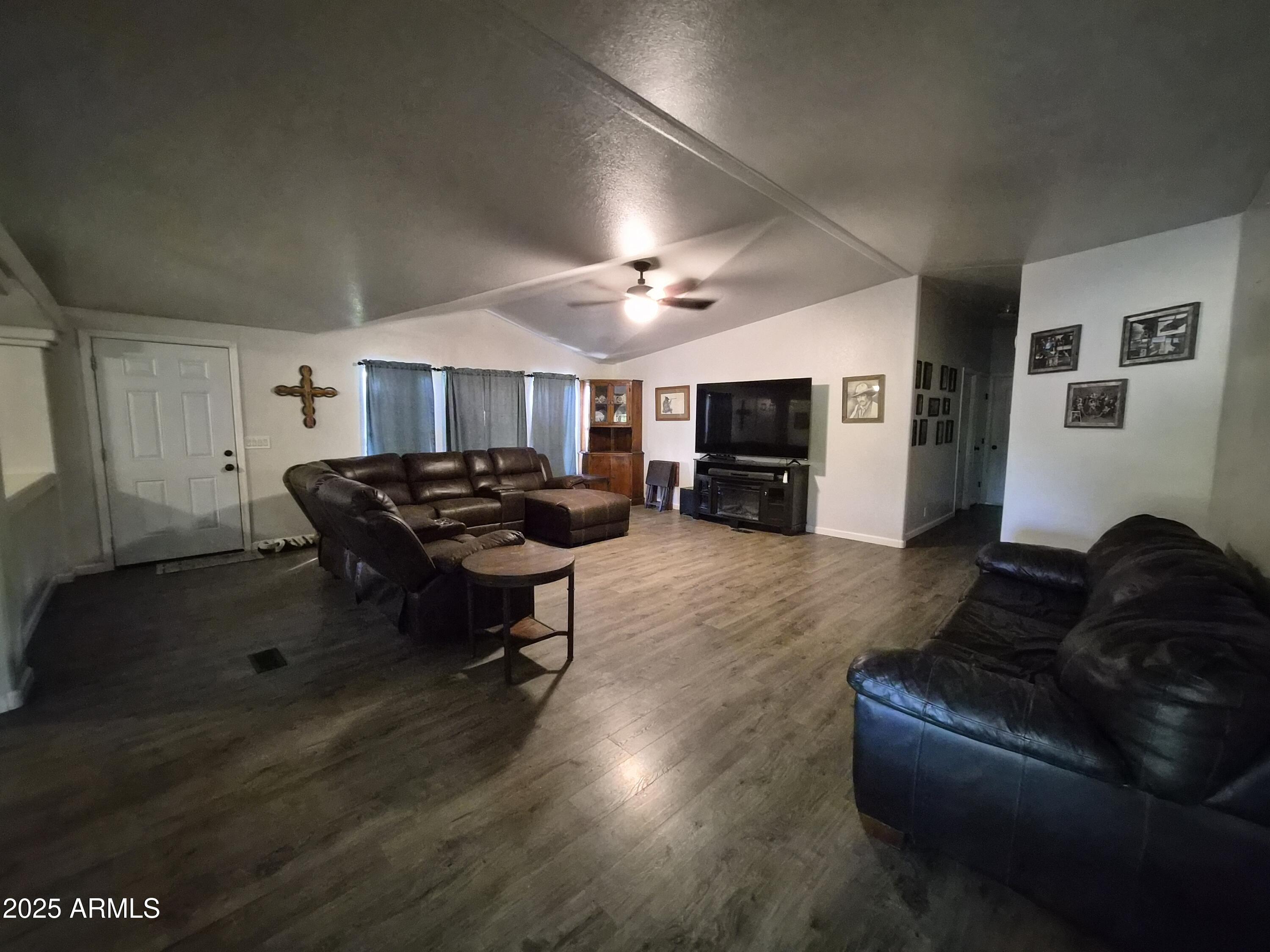 51033 North Mockingbird Road Wickenburg, AZ 85390 - Photo 13 of 51 a living room with furniture and a fireplace