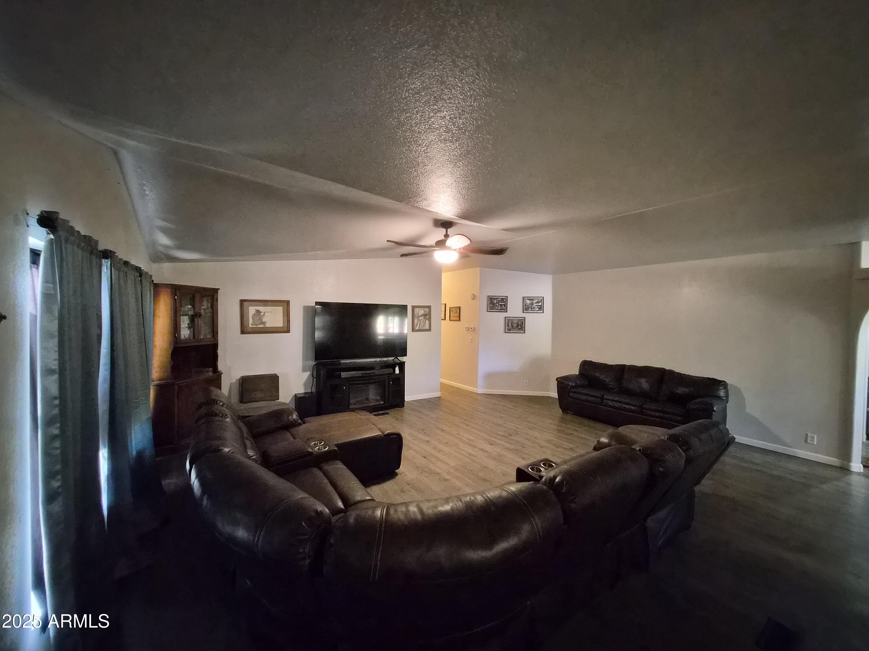 51033 North Mockingbird Road Wickenburg, AZ 85390 - Photo 14 of 51 a living room with furniture and a flat screen tv