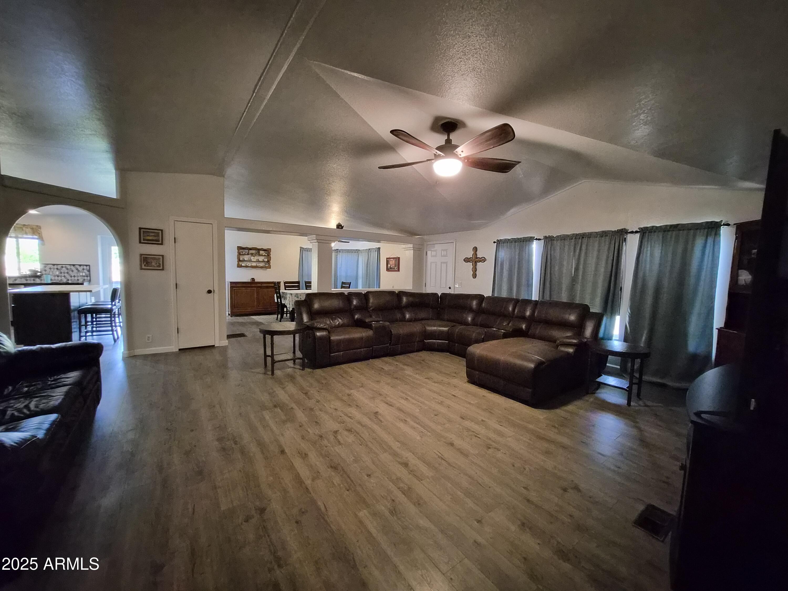 51033 North Mockingbird Road Wickenburg, AZ 85390 - Photo 15 of 51 a living room with furniture and a flat screen tv