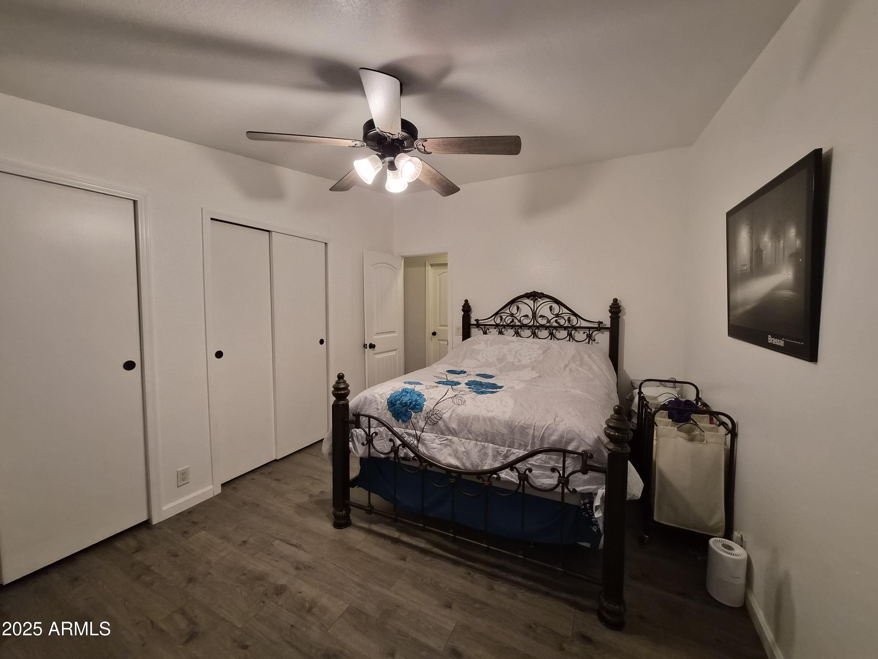 51033 North Mockingbird Road Wickenburg, AZ 85390 - Photo 21 of 51 a bedroom with a bed and a chandelier