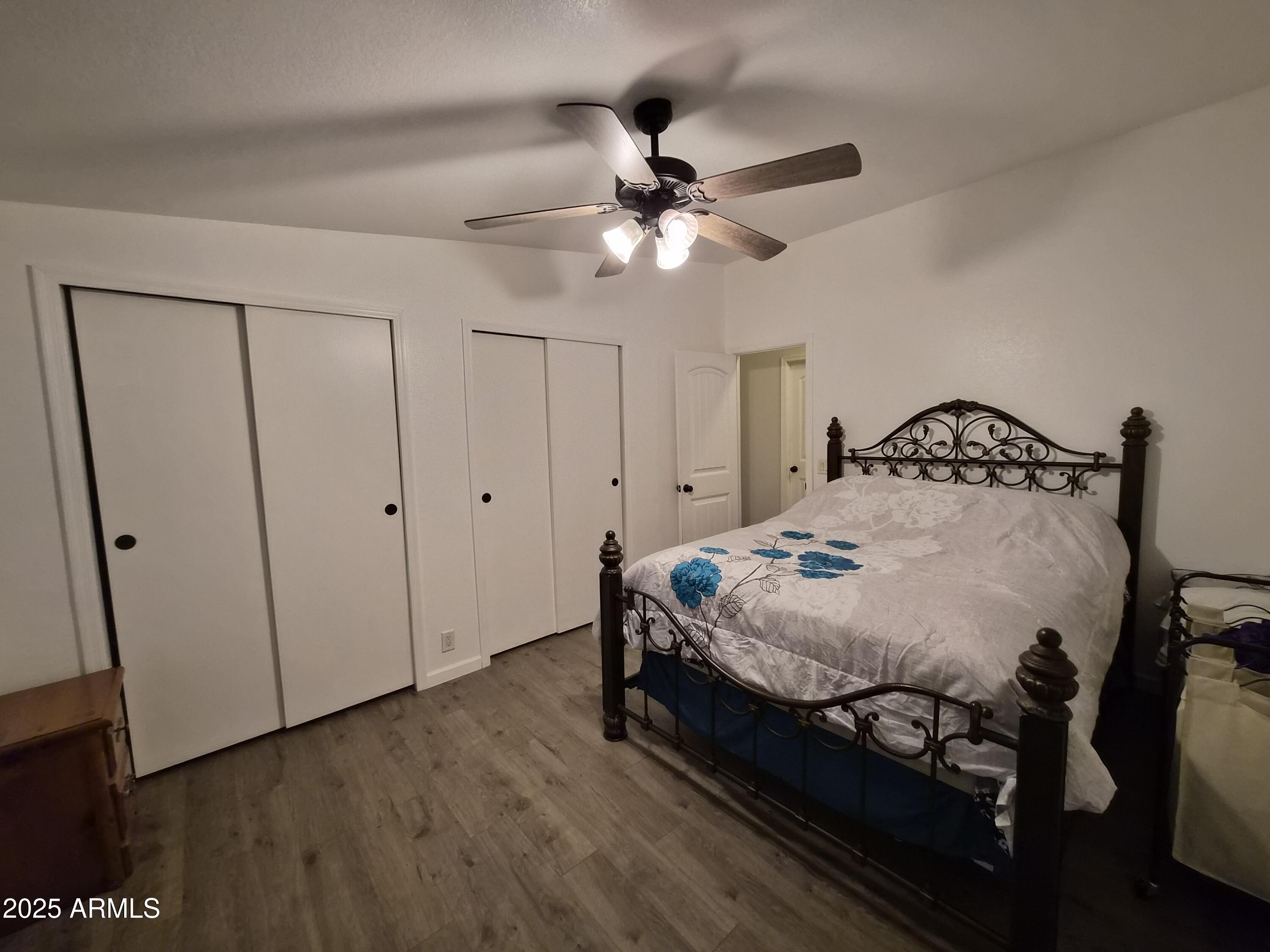 51033 North Mockingbird Road Wickenburg, AZ 85390 - Photo 22 of 51 a bedroom with a bed and a chandelier
