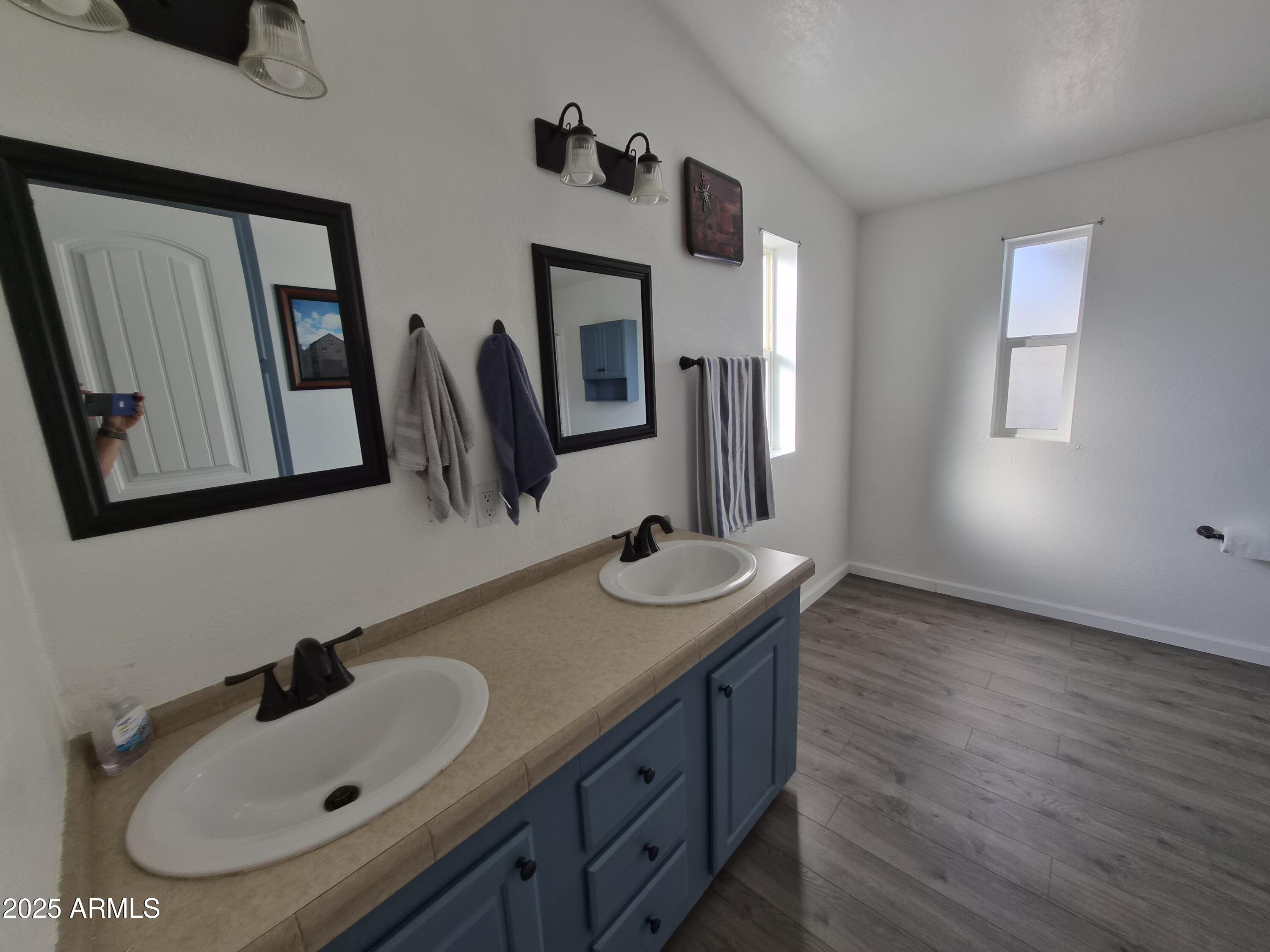 51033 North Mockingbird Road Wickenburg, AZ 85390 - Photo 25 of 51 a bathroom with a sink and a mirror