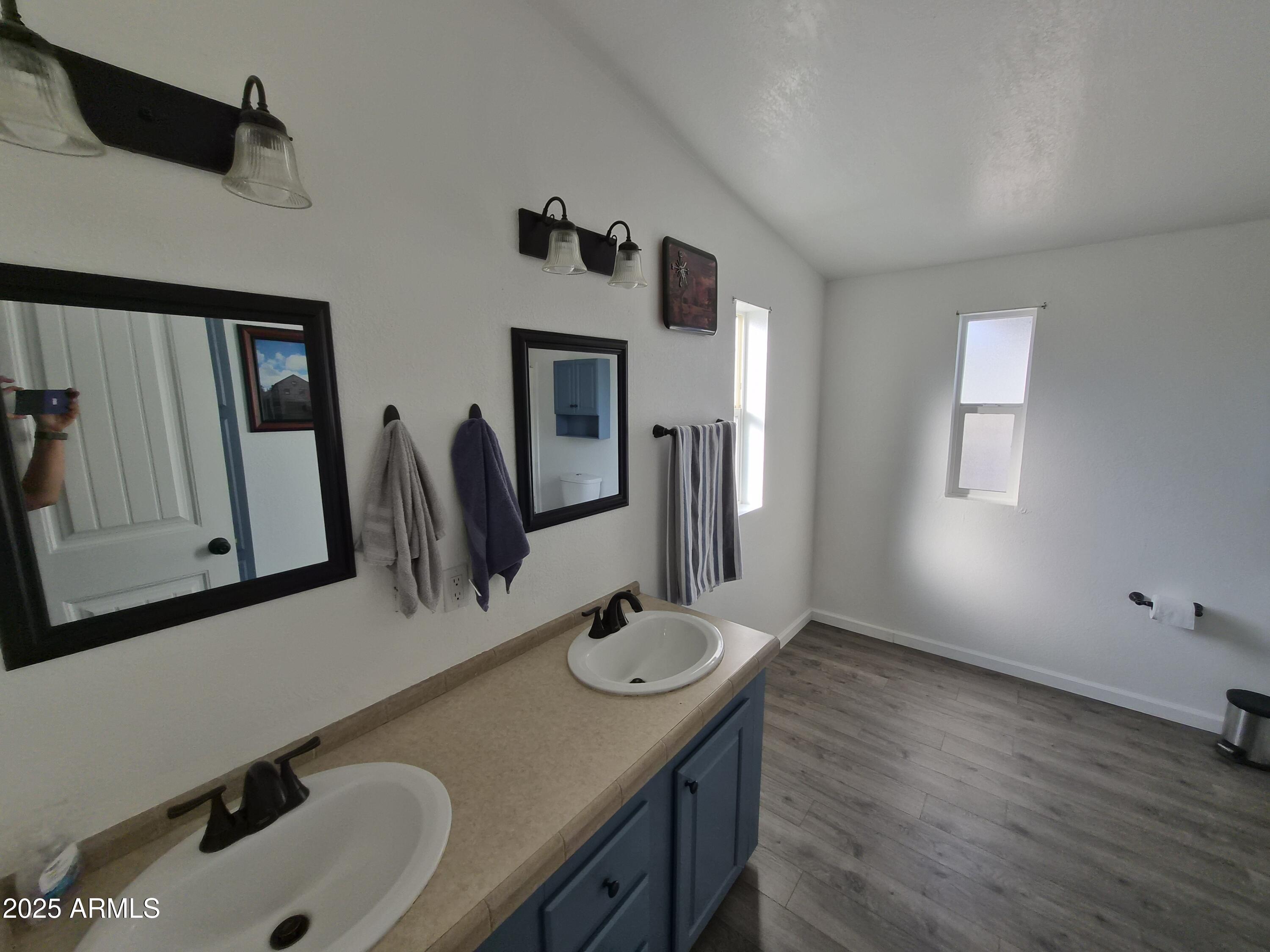51033 North Mockingbird Road Wickenburg, AZ 85390 - Photo 26 of 51 a bathroom with a double vanity sink and a mirror