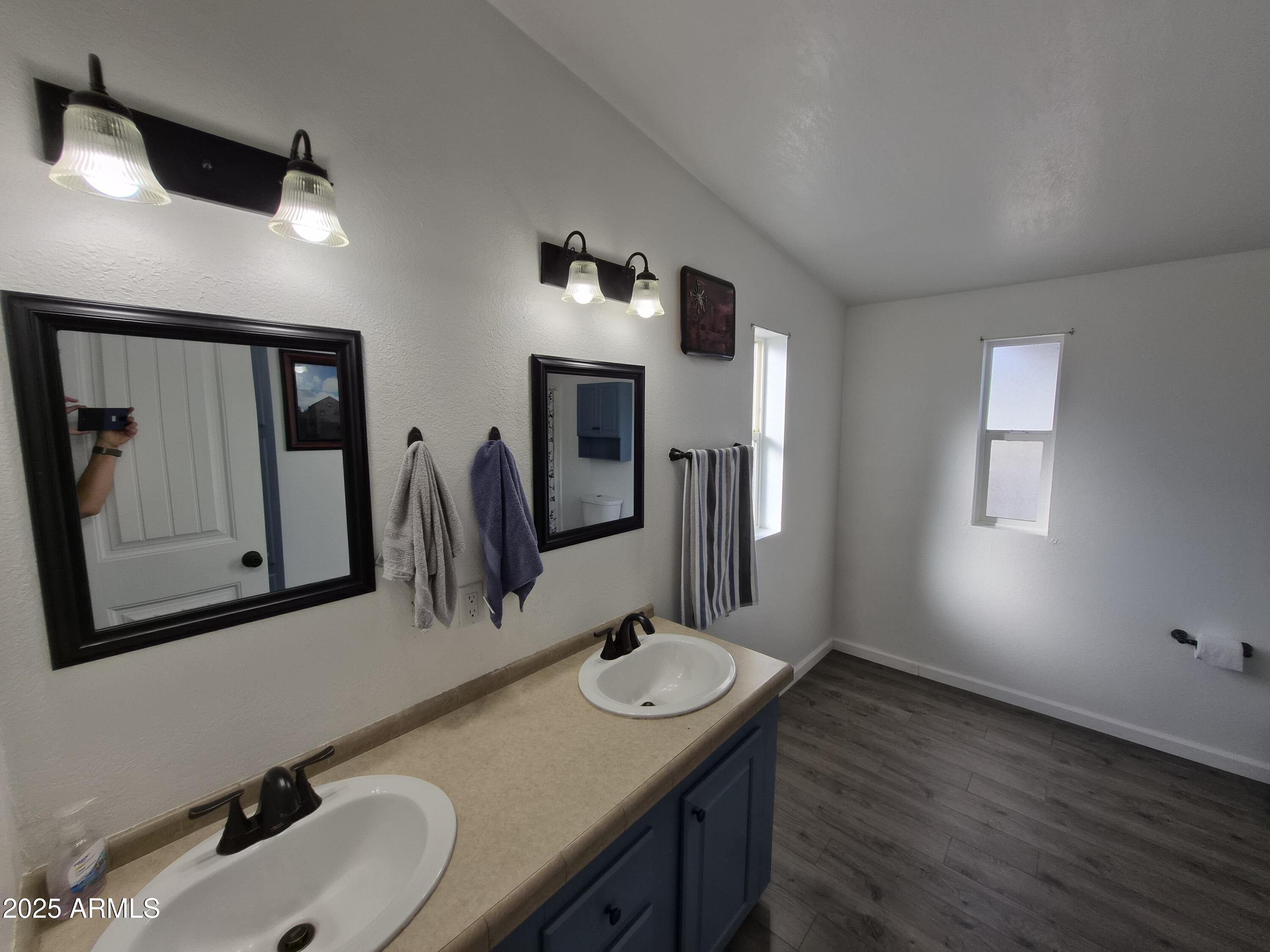 51033 North Mockingbird Road Wickenburg, AZ 85390 - Photo 29 of 51 a bathroom with a granite countertop sink a mirror and vanity