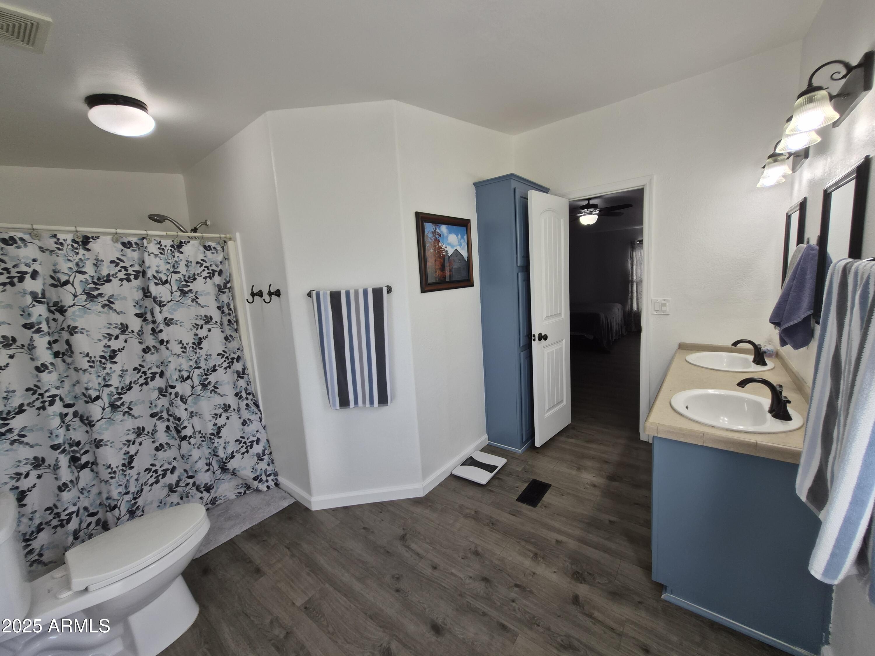 51033 North Mockingbird Road Wickenburg, AZ 85390 - Photo 31 of 51 a view of a hallway with wooden floor and furniture