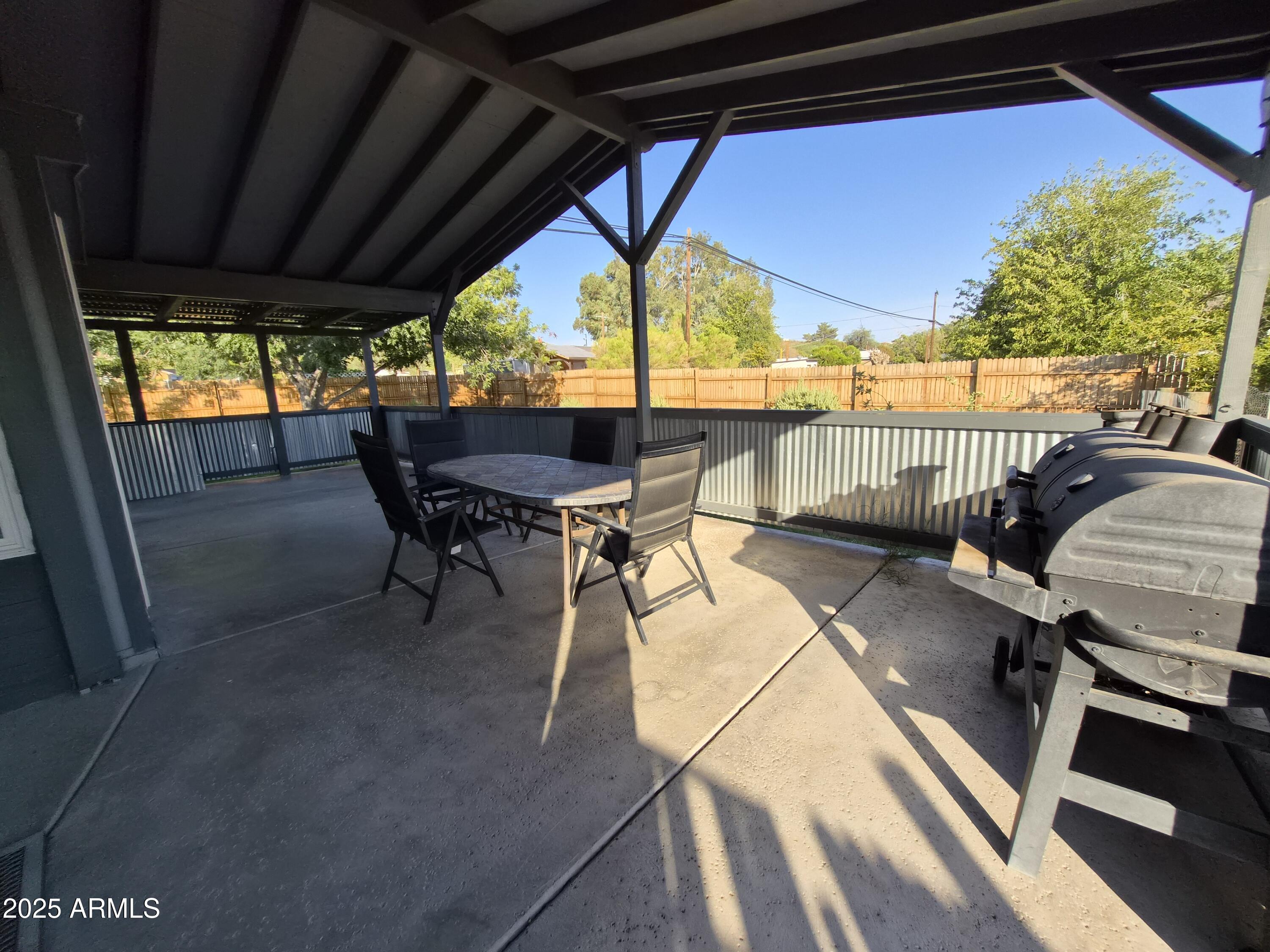 51033 North Mockingbird Road Wickenburg, AZ 85390 - Photo 38 of 51 a view of a patio with a table chairs and a backyard