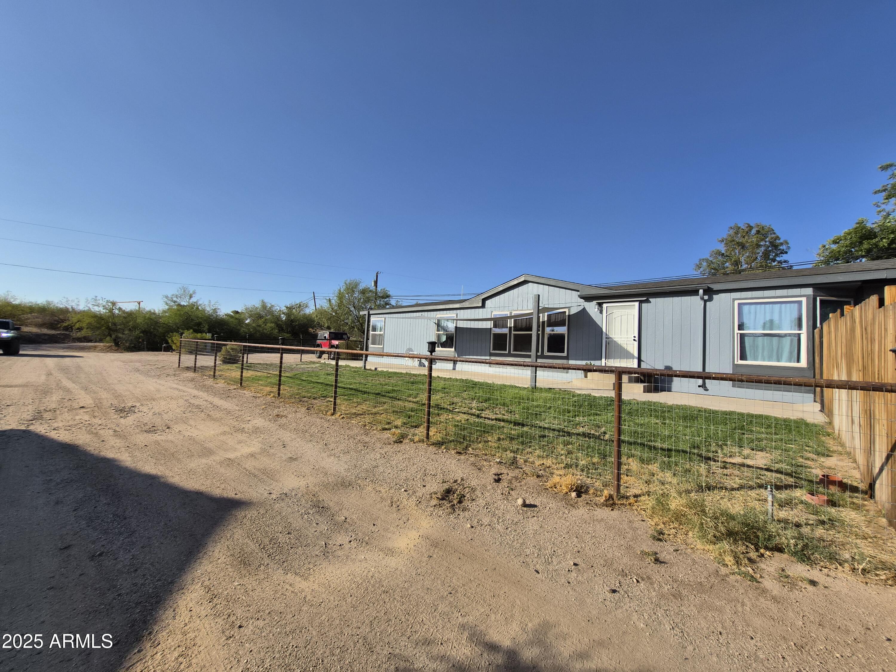 51033 North Mockingbird Road Wickenburg, AZ 85390 - Photo 4 of 51 a view of a house with backyard and sitting area