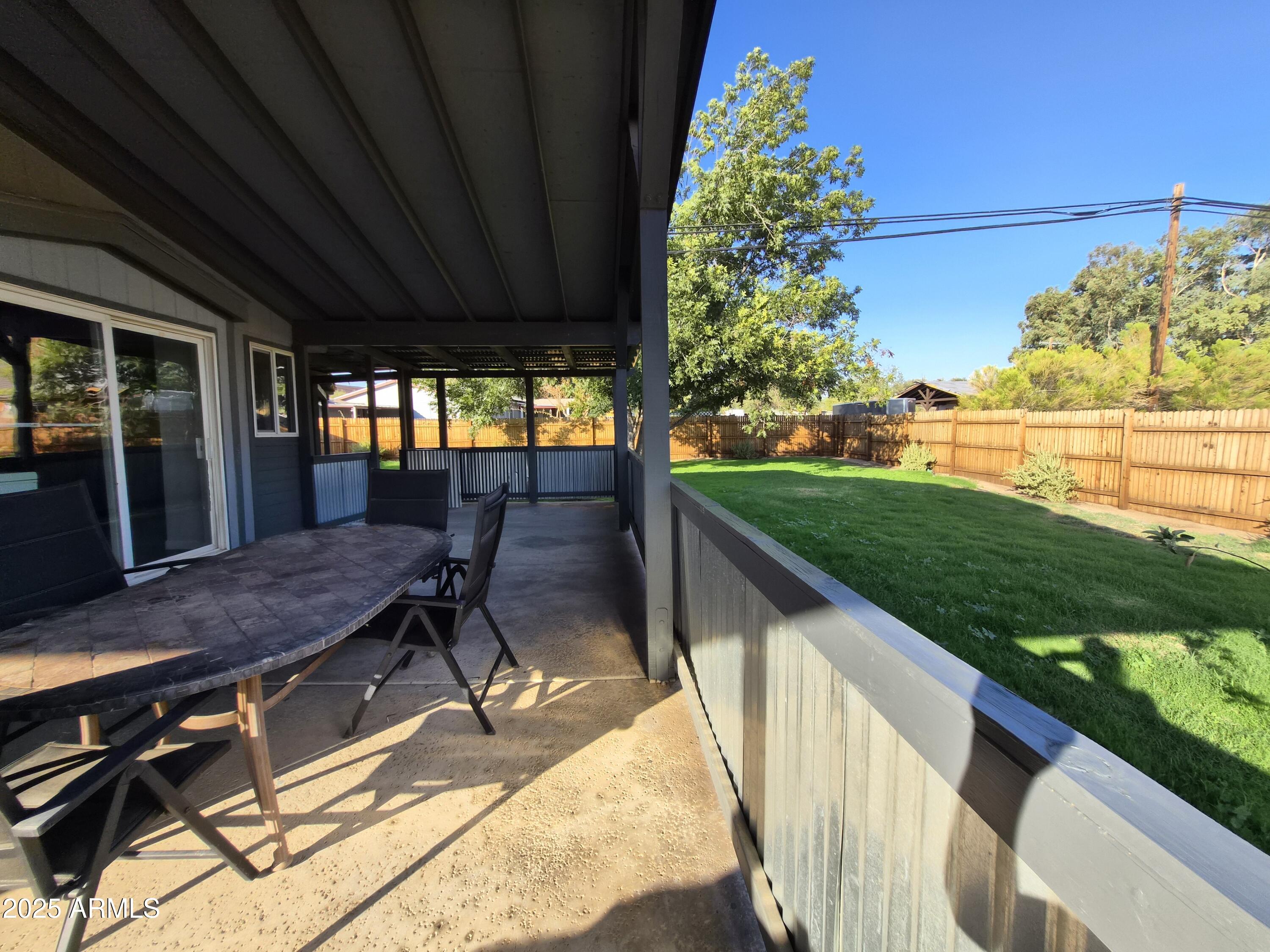 51033 North Mockingbird Road Wickenburg, AZ 85390 - Photo 41 of 51 a balcony with table and chairs