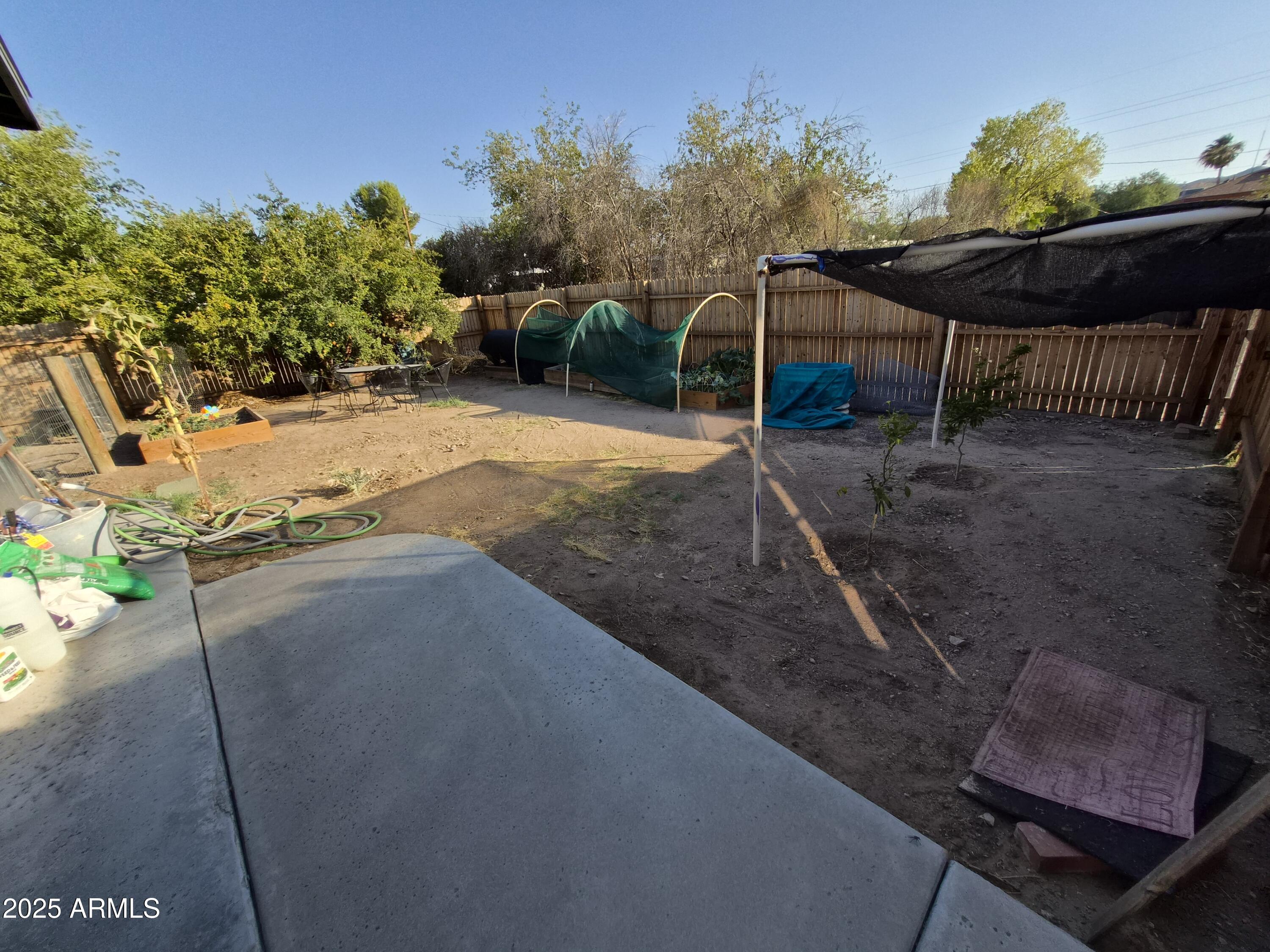 51033 North Mockingbird Road Wickenburg, AZ 85390 - Photo 46 of 51 a backyard of a house with table and chairs
