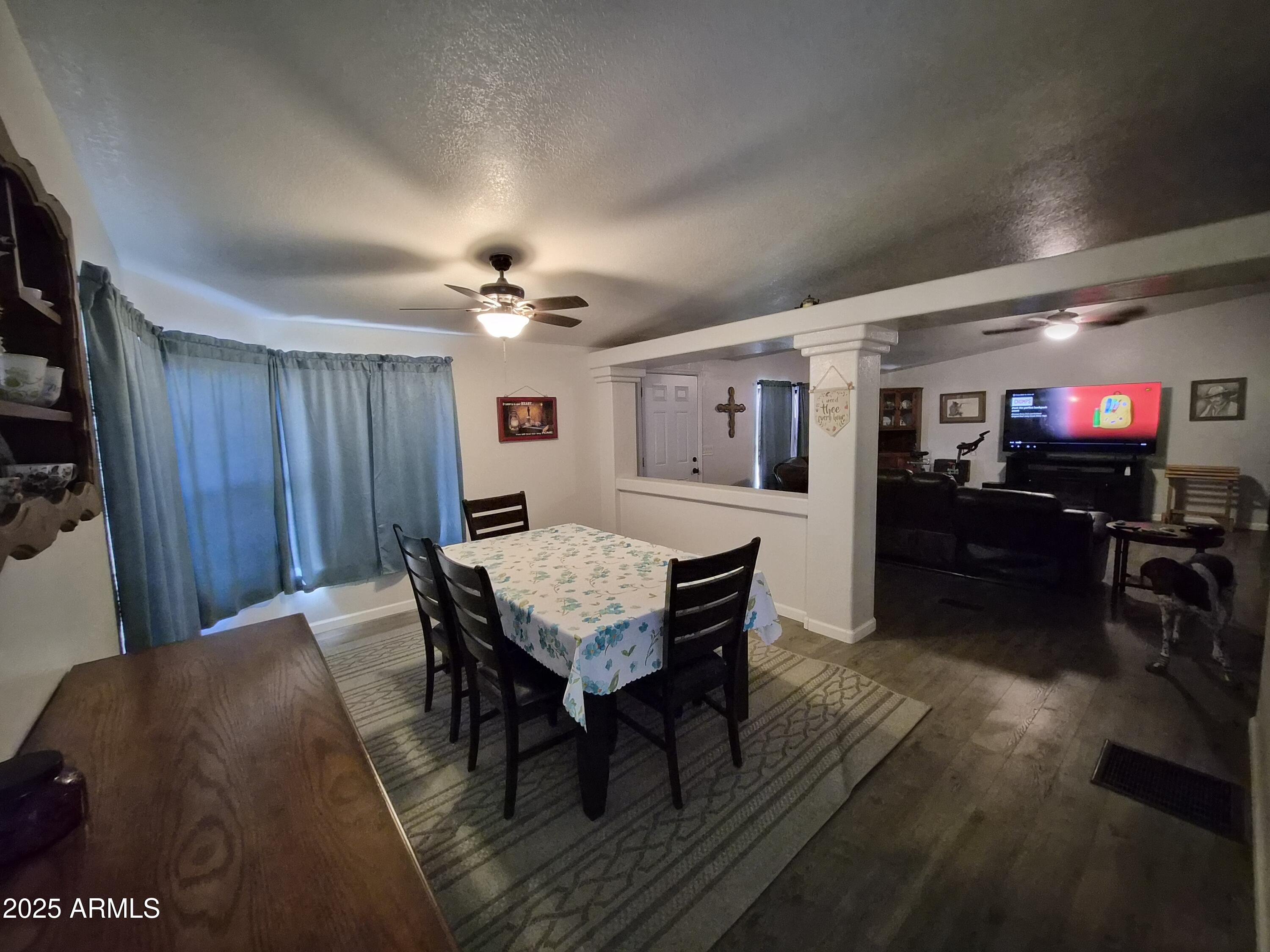 51033 North Mockingbird Road Wickenburg, AZ 85390 - Photo 8 of 51 a view of a dining room with furniture and wooden floor