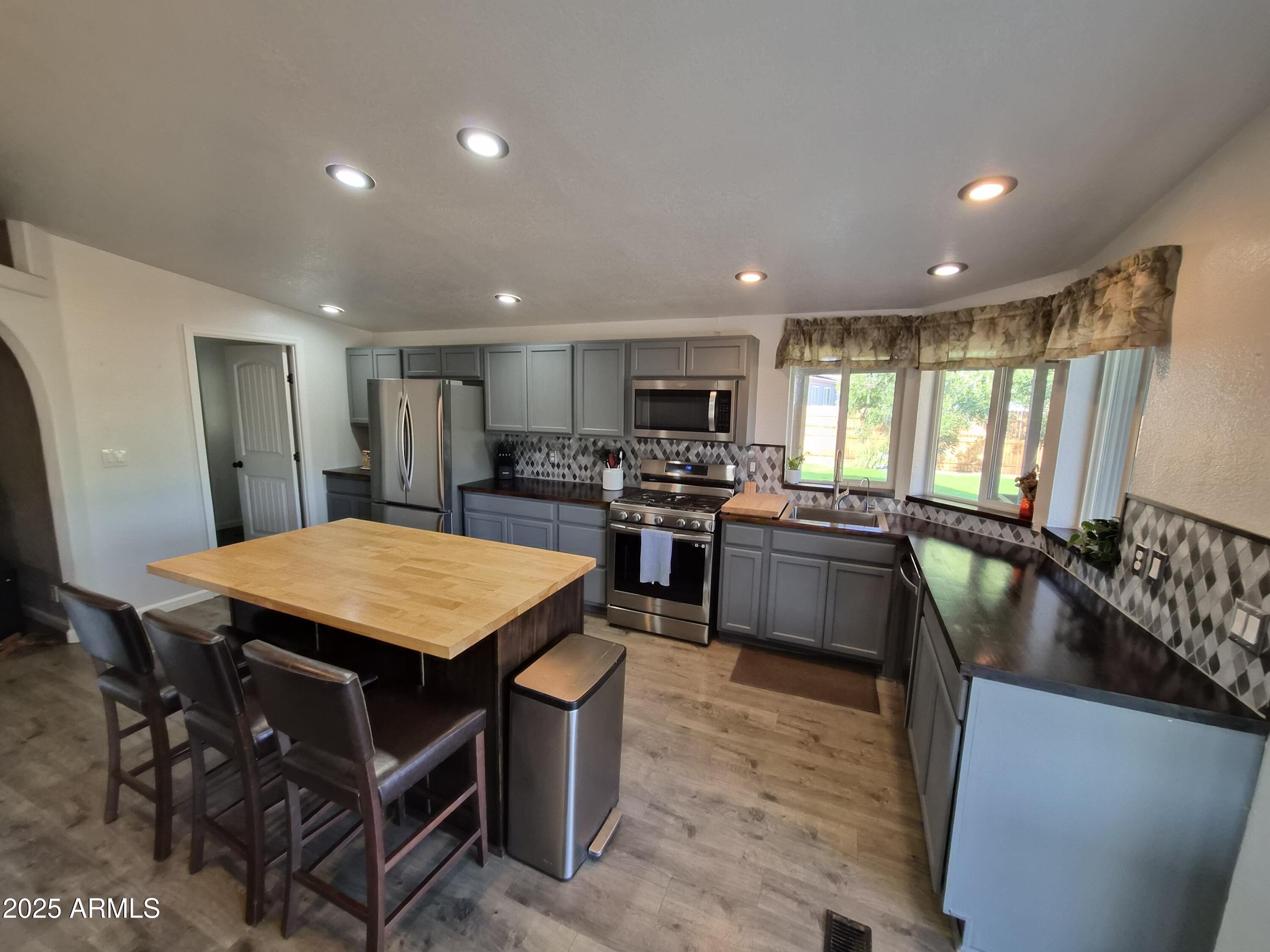 51033 North Mockingbird Road Wickenburg, AZ 85390 - Photo 9 of 51 a large kitchen with a table and chairs