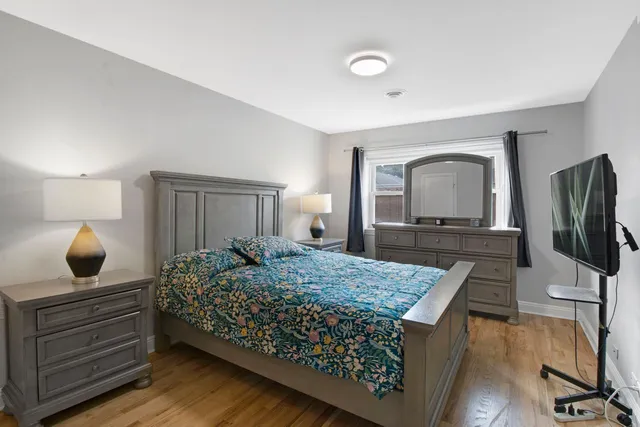 a bedroom with a bed and a dresser in it