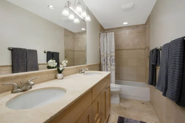 a bathroom with double vanity sink and a mirror
