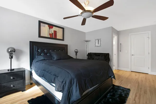 a bedroom with a bed and a chandelier