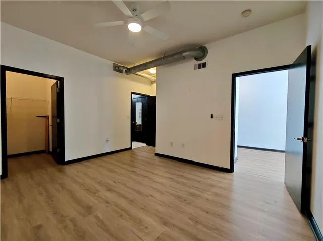 a view of a livingroom with wooden floor and closet area