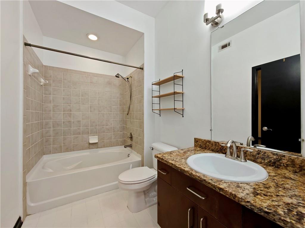 5300 Peachtree Road, Unit 2401 Chamblee, GA 30341 - Photo 14 of 24 a bathroom with a granite countertop sink toilet and shower
