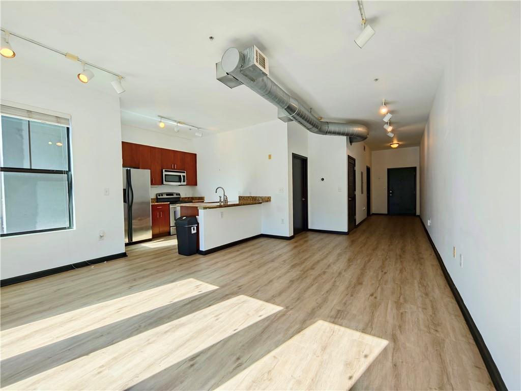 5300 Peachtree Road, Unit 2401 Chamblee, GA 30341 - Photo 5 of 24 a view of a kitchen with furniture and wooden floor