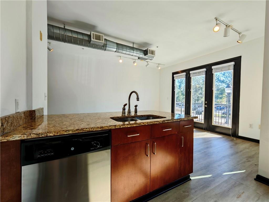 5300 Peachtree Road, Unit 2401 Chamblee, GA 30341 - Photo 9 of 24 a kitchen with granite countertop stainless steel appliances a sink and wooden floor