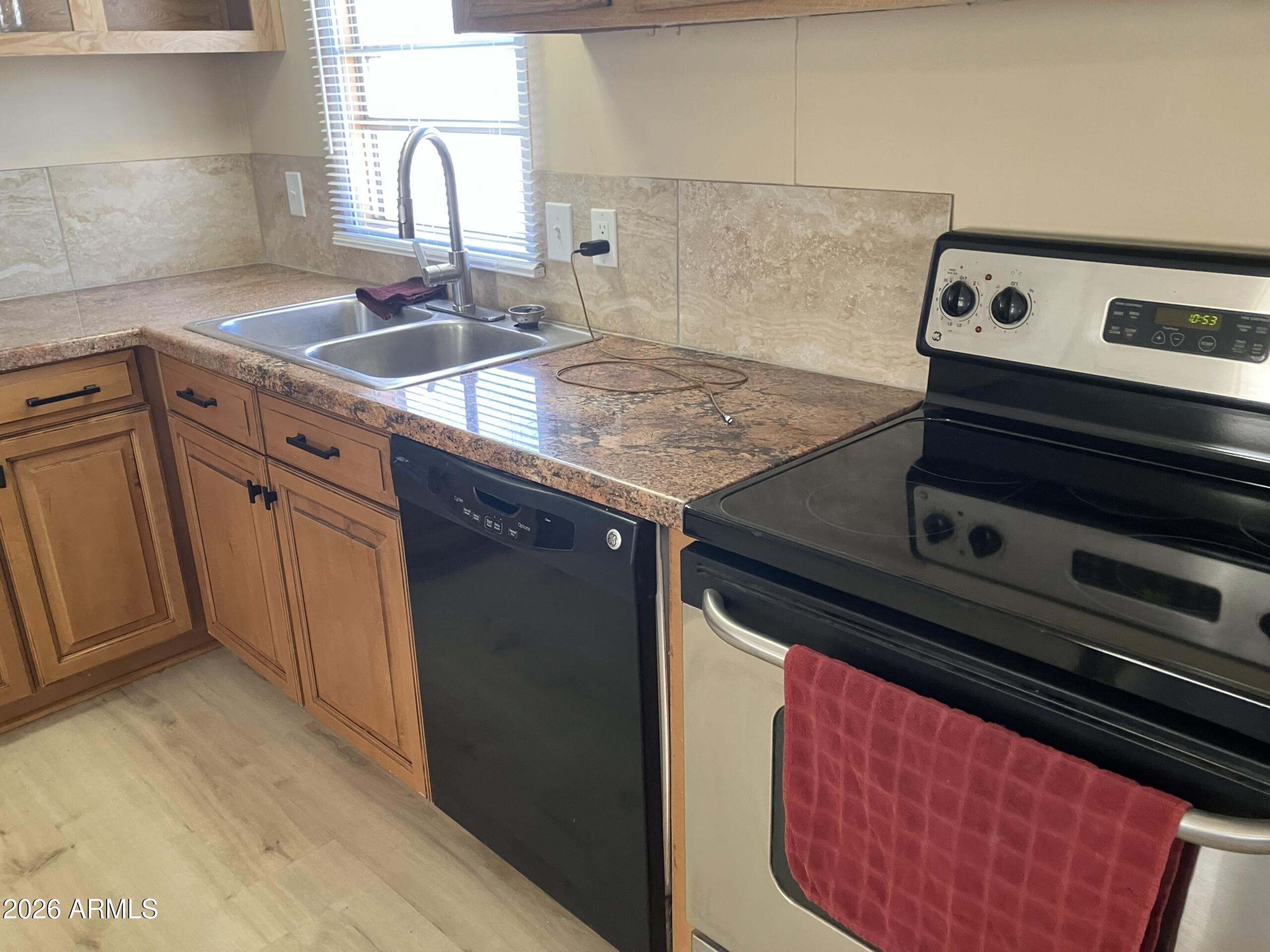 2523 East Contention Mine Road, Unit 41 Phoenix, AZ 85032 - Photo 10 of 19 a kitchen with a stove and a sink