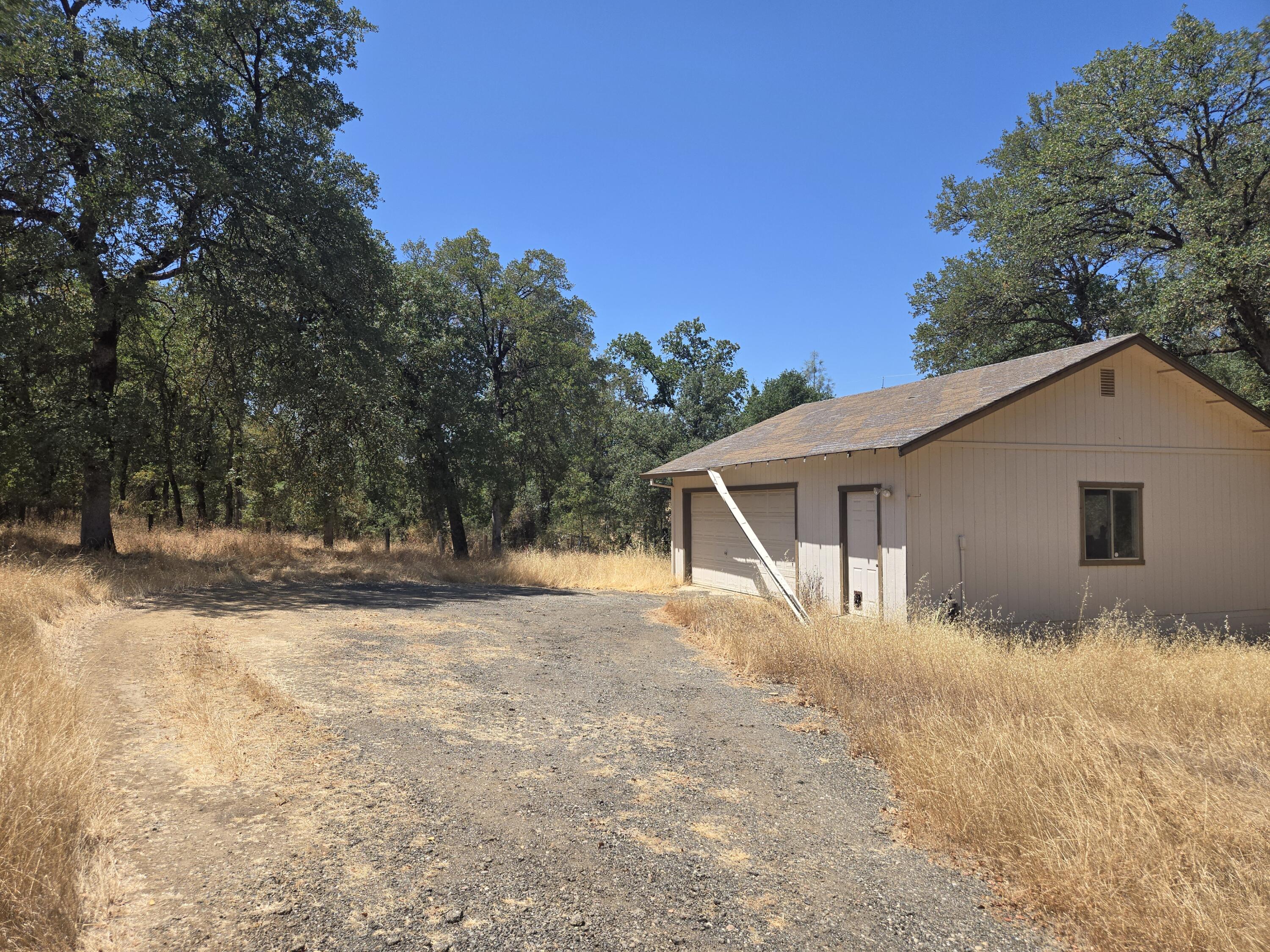 18353 Old Oasis Road Redding, CA 96003 - Photo 22 of 22 a backyard of house with large trees