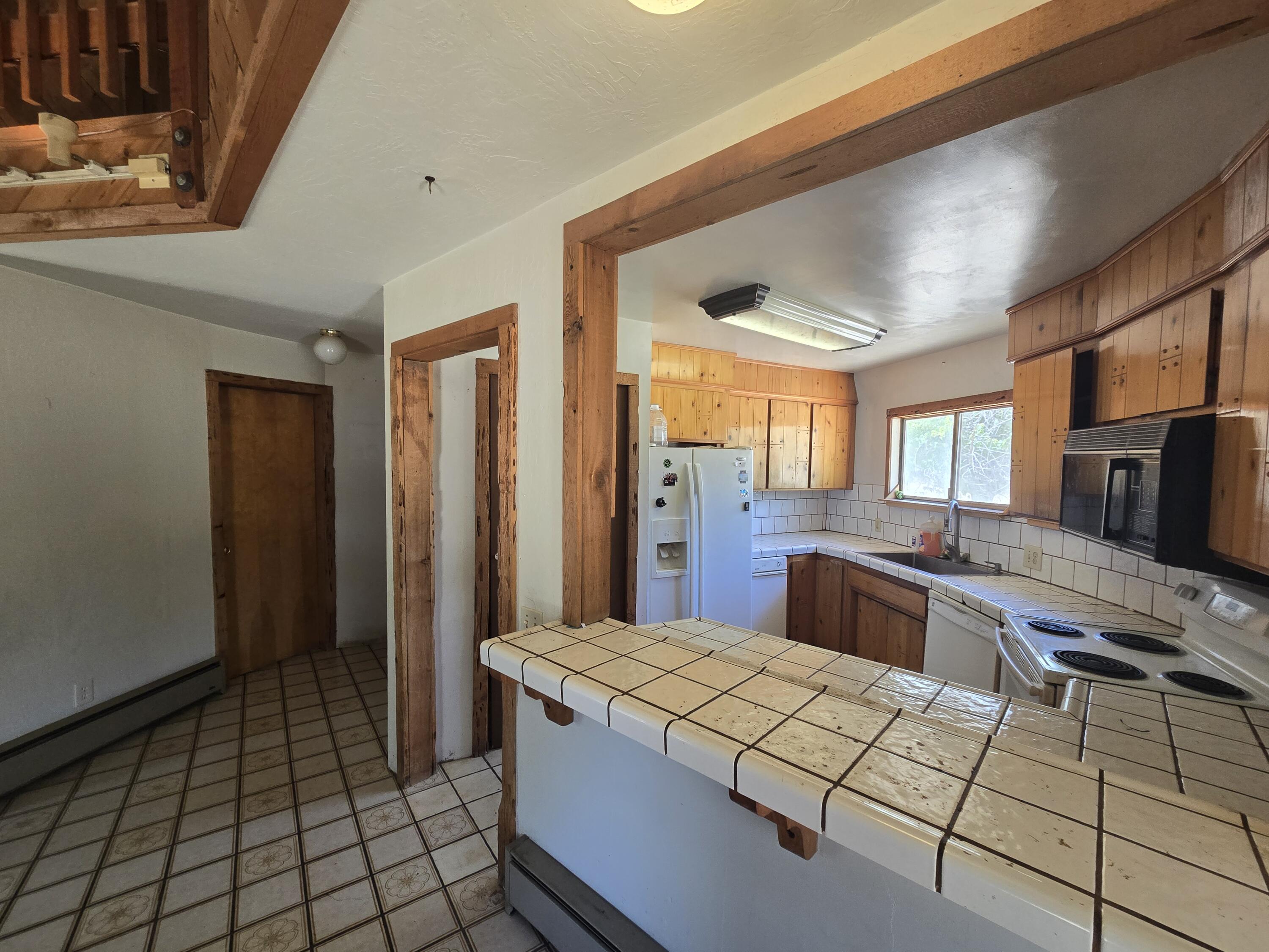 18353 Old Oasis Road Redding, CA 96003 - Photo 7 of 22 a kitchen with stainless steel appliances kitchen island granite countertop a refrigerator and a stove top oven