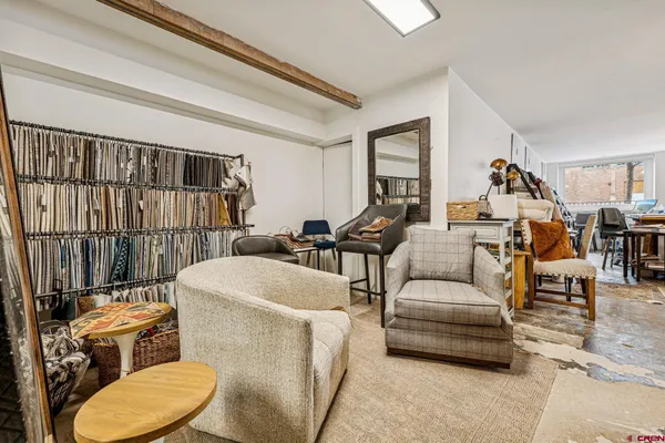 a living room with furniture a air conditioner vent and a window