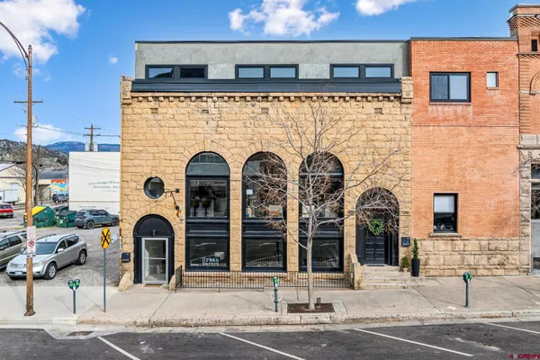 a front view of a building with parking