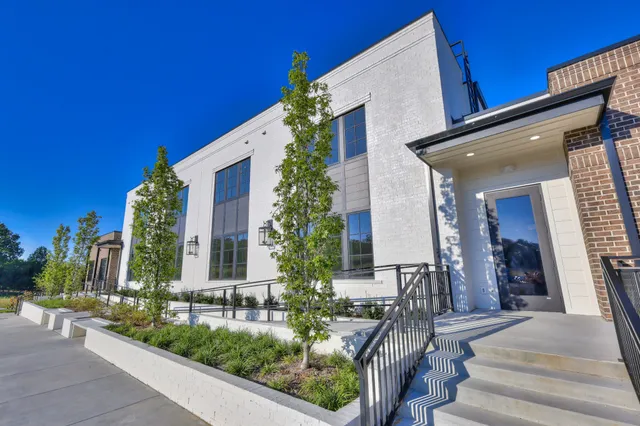 a view of a balcony with potted plants and wooden fence