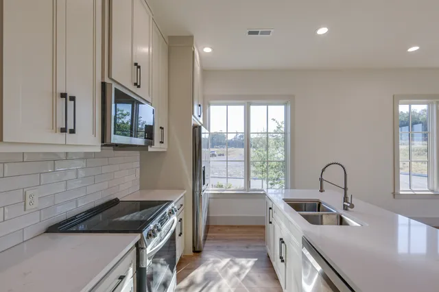 a kitchen that has a sink and a stove in it