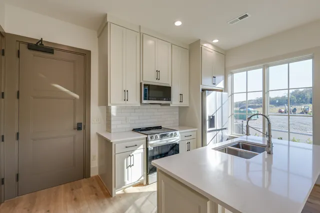 a kitchen with a refrigerator a sink and a stove