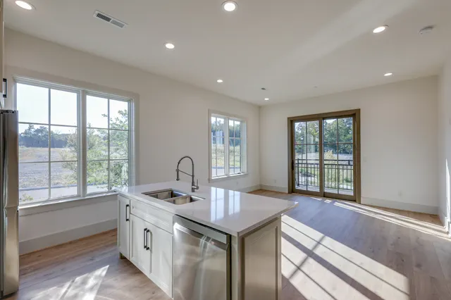 a kitchen with a sink and large window