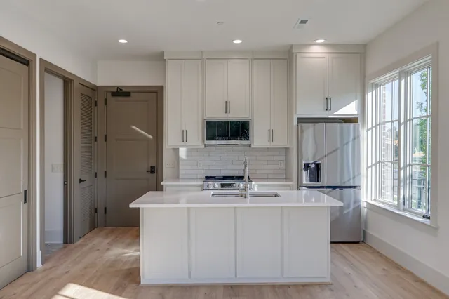 a bathroom with a double vanity sink a mirror a and a shower