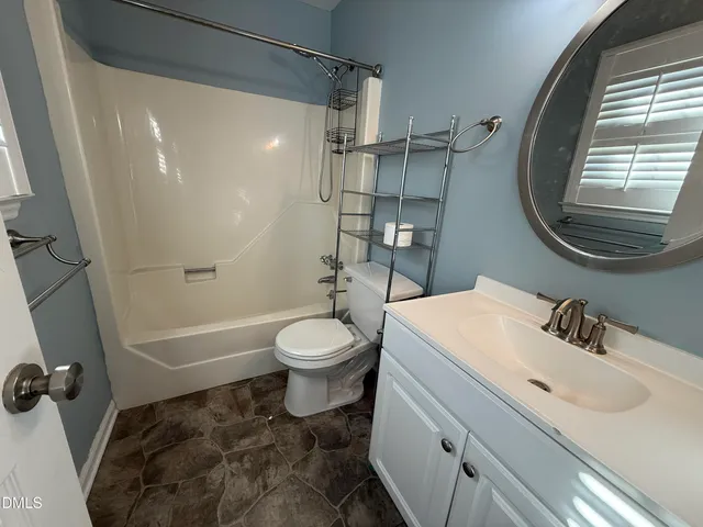 a view of a hallway with wooden floor and a cabinet