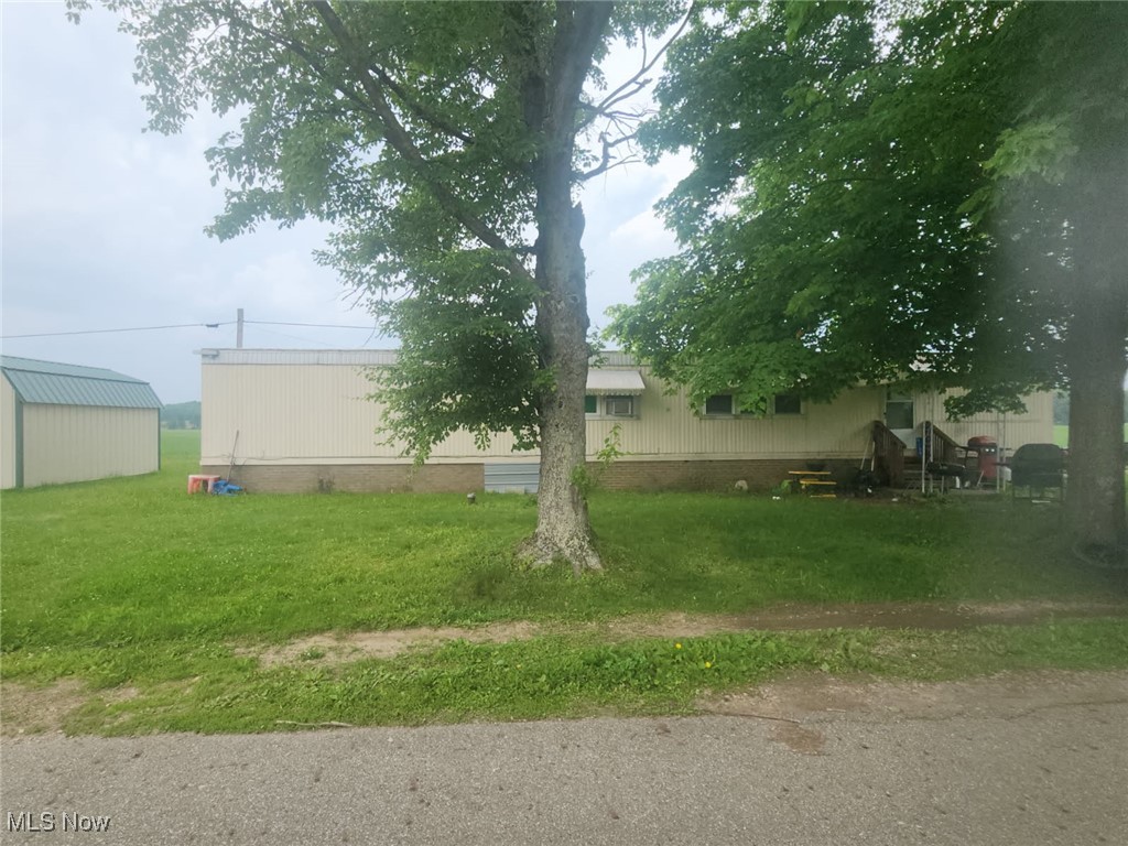 4139 Terminal Road Sandyville, OH 44671 - Photo 4 of 4 View of green lawn with an outbuilding