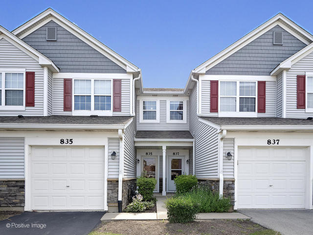 a view of a house with a yard and garage