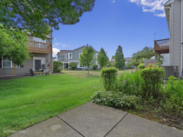 835 Genesee Drive Naperville, IL 60563 - Photo 16 of 18 a view of a building with a yard