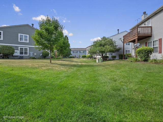 835 Genesee Drive Naperville, IL 60563 - Photo 17 of 18 a view of a house with a yard