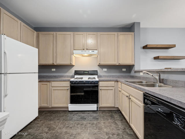 835 Genesee Drive Naperville, IL 60563 - Photo 5 of 18 a kitchen with stainless steel appliances granite countertop a stove a sink and a refrigerator