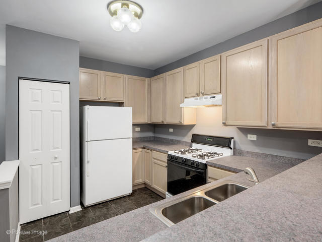 835 Genesee Drive Naperville, IL 60563 - Photo 6 of 18 a kitchen with stainless steel appliances granite countertop a stove a refrigerator and a granite counter tops