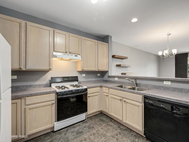 835 Genesee Drive Naperville, IL 60563 - Photo 7 of 18 a kitchen with a stove sink and cabinets