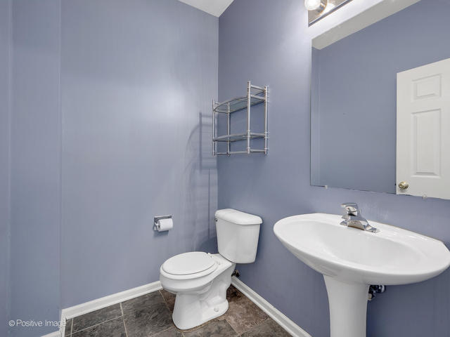 835 Genesee Drive Naperville, IL 60563 - Photo 9 of 18 a bathroom with a sink a toilet and mirror