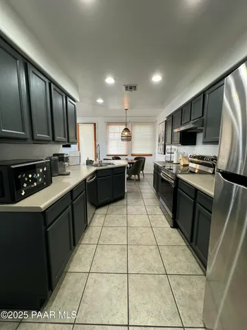 a kitchen with stainless steel appliances a sink stove and refrigerator
