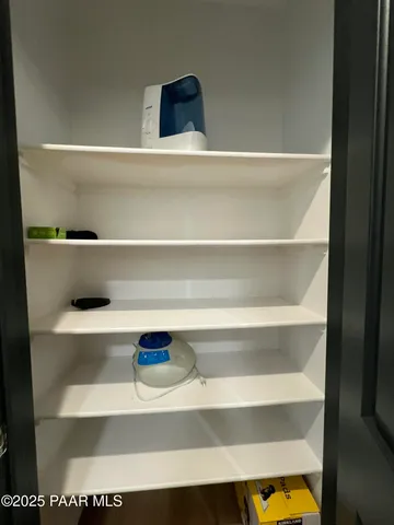 a white toilet sitting next to a white wall