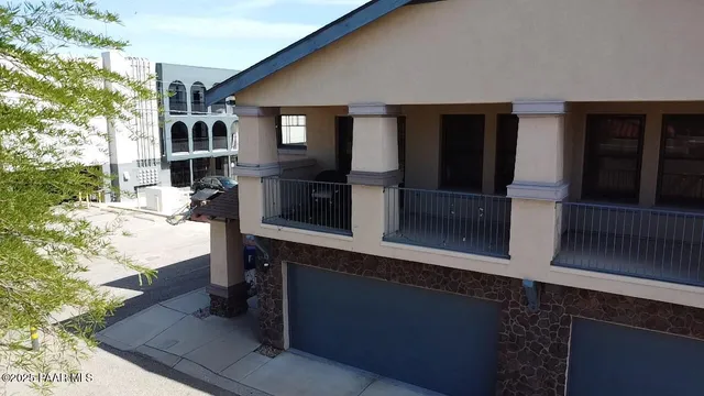 a living room with patio furniture and a potted plant